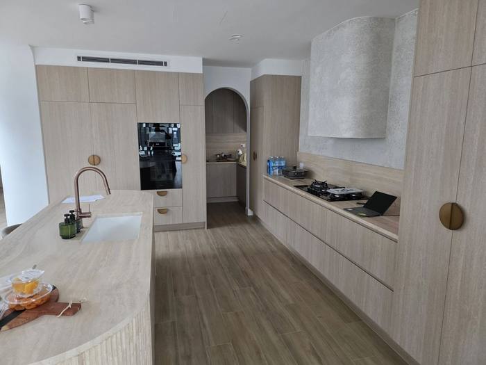 Open-plan kitchen renovation with island bench and integrated appliances