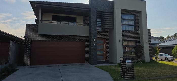 Two-storey new home build with brick and stacked stone facade, Sydney